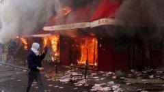 Violent clashes, looting and buildings ablaze in France as over 1,200 arrested after protests